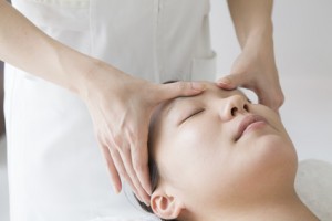 Women undergoing massage of face